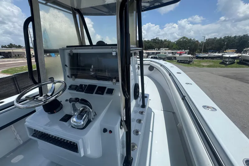 Slide: The Image of 2007 Contender 33 Tournament boat cockpit with steering wheel and control panel. - 28