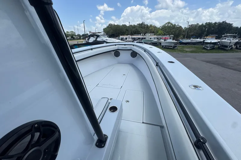 Slide: The Image of 2007 Contender 33 Tournament boat deck, showcasing spacious layout and sleek design under a cloudy sky. - 39