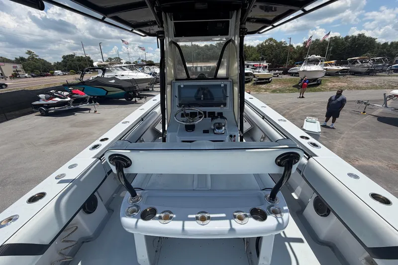 Slide: The Image of 2007 Contender 33 Tournament boat interior with helm, rod holders, and marina background. - 13