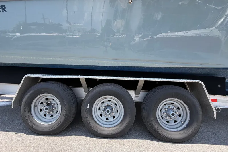 Slide: The Image of Triple-axle trailer supporting a 2007 Contender 33 Tournament boat. - 33