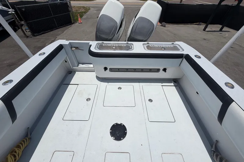 Slide: The Image of 2007 Contender 33 Tournament boat deck with storage compartments and dual engines. - 28