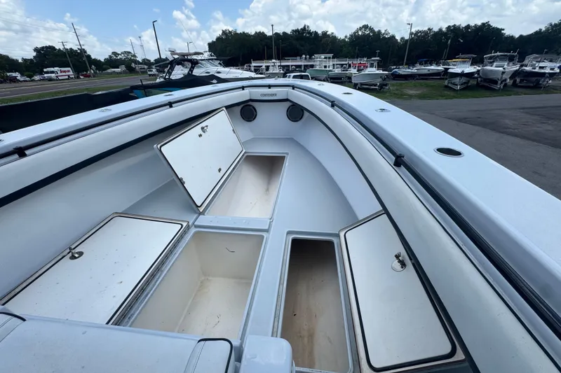 Slide: The Image of 2007 Contender 33 Tournament boat with open storage compartments, docked outdoors. - 41