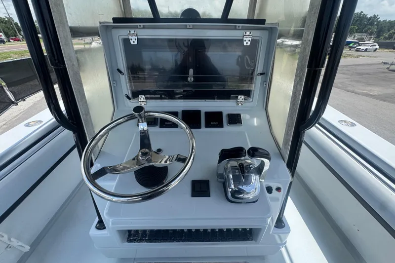 Slide: The Image of 2007 Contender 33 Tournament boat helm with steering wheel and controls. - 31