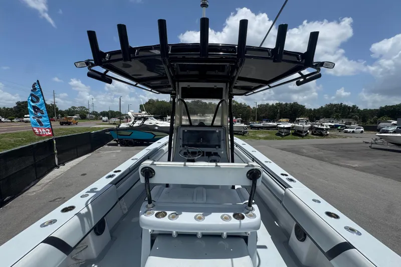Slide: The Image of 2007 Contender 33 Tournament boat with T-top, docked in a marina under a clear sky. - 20