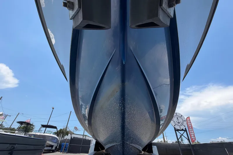 Slide: The Image of Close-up of the hull of a blue Contender 33 Tournament boat on a trailer. - 11