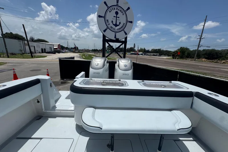 Slide: The Image of 2007 Contender 33 Tournament boat with dual Suzuki 350 engines, displayed outdoors. - 64