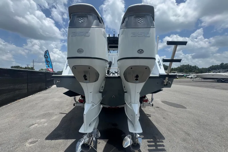 Slide: The Image of 2007 Contender 33 Tournament boat with twin Suzuki 350 outboard engines, parked outdoors. - 5