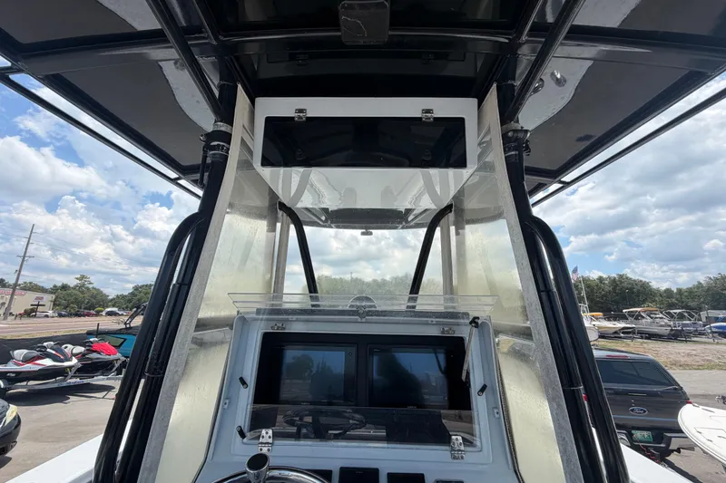 Slide: The Image of 2007 Contender 33 Tournament boat console with navigation screens and overhead storage. - 18