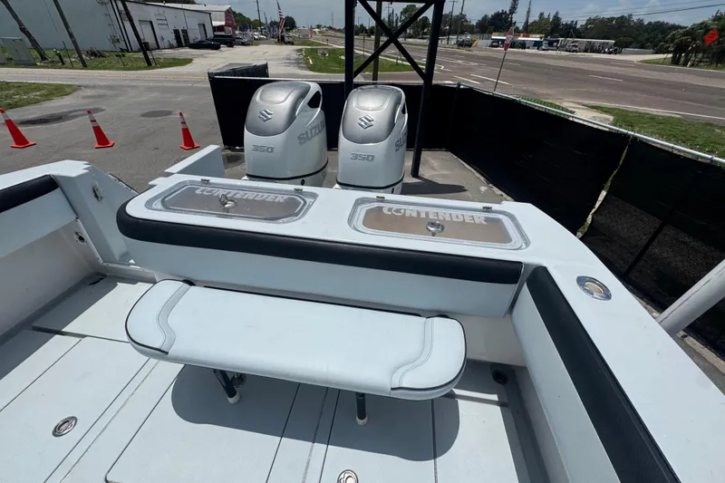 Slide: The Image of 2007 Contender 33 Tournament boat with dual Suzuki 350 engines, docked outdoors. - 63