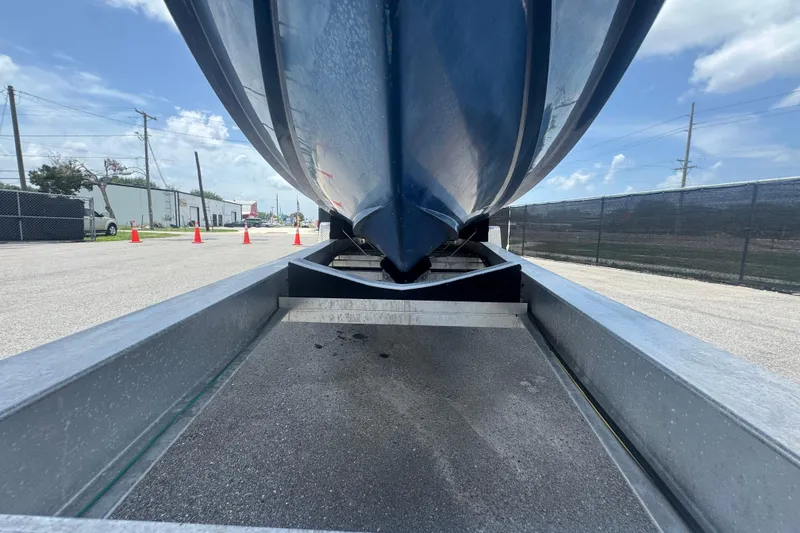 Slide: The Image of 2007 Contender 33 Tournament boat on trailer, viewed from below, with clear sky background. - 19