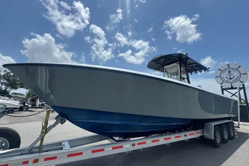 Slide: The Image of A 2007 Contender 33 Tournament on a trailer, featuring a blue hull and T-top, under a blue sky. - 14