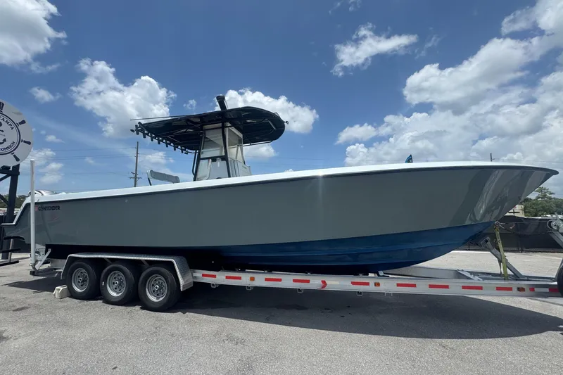 Slide: The Image of A 2007 Contender 33 Tournament boat on a trailer, featuring a blue hull and T-top. - 1