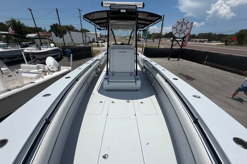 Slide: The Image of 2007 Contender 33 Tournament boat with spacious deck, parked outdoors under clear skies. - 22