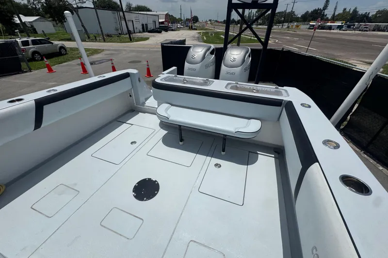 Slide: The Image of 2007 Contender 33 Tournament boat deck with dual Suzuki 350 engines, parked outdoors. - 62