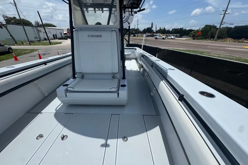 Slide: The Image of 2007 Contender 33 Tournament boat deck with seating, parked near a road under a clear sky. - 46