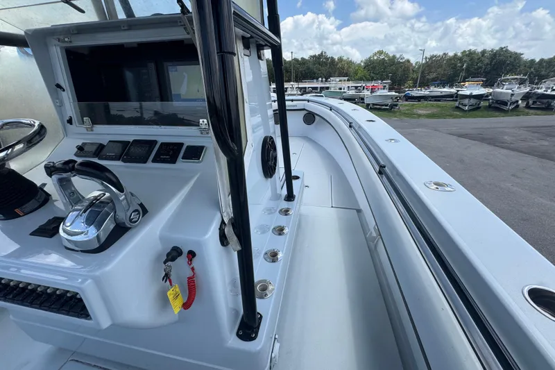 Slide: The Image of 2007 Contender 33 Tournament boat cockpit with controls and spacious deck under a clear sky. - 38