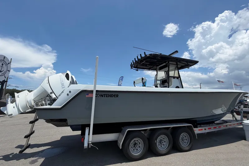 Slide: The Image of 2007 Contender 33 Tournament on a trailer, featuring twin outboard engines and a black T-top. - 7