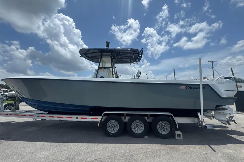 Slide: The Image of 2007 Contender 33 Tournament boat on trailer under a partly cloudy sky. - 13