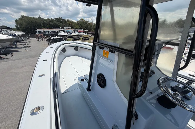 Slide: The Image of 2007 Contender 33 Tournament boat, showcasing spacious deck and steering console under cloudy skies. - 19
