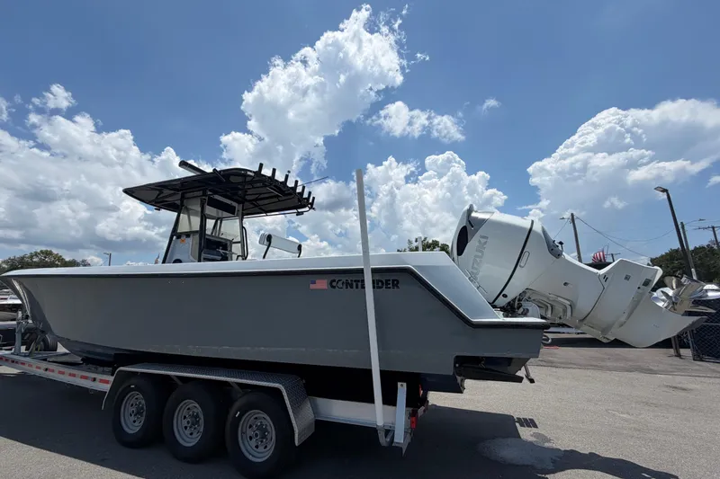 Slide: The Image of A 2007 Contender 33 Tournament boat on a trailer, featuring two outboard engines. - 2