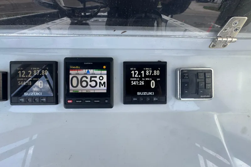 Slide: The Image of Dashboard of a 2007 Contender 33 Tournament boat with Suzuki and Garmin displays. - 35