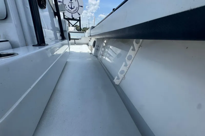 Slide: The Image of 2007 Contender 33 Tournament boat interior, showcasing sleek white deck and storage features. - 54