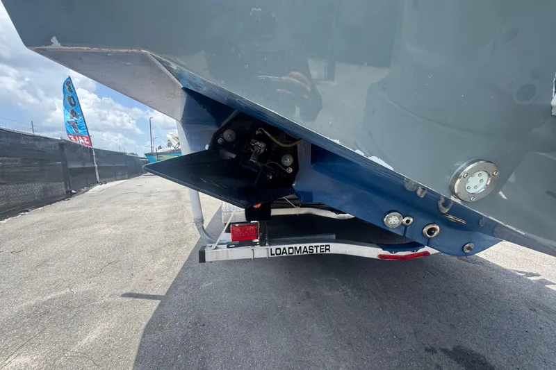 Slide: The Image of 2007 Contender 33 Tournament boat on Loadmaster trailer, rear view with trim tabs visible. - 10