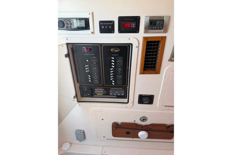 Slide: The Image of Control panel of a 2008 Grady-White Canyon 336 boat, featuring various switches and displays. - 11