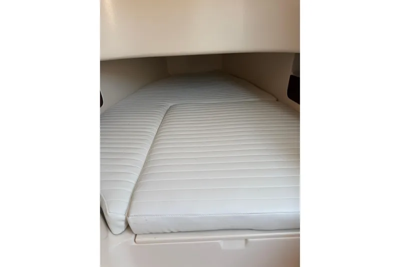 Slide: The Image of 2008 Grady-White Canyon 336 cabin interior with white cushioned bedding. - 12