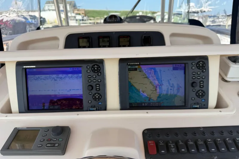 Slide: The Image of Dashboard of a 2008 Grady-White Canyon 336 with navigation and sonar displays. - 3