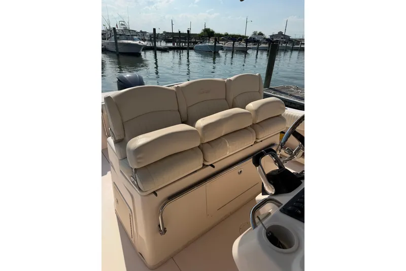 Slide: The Image of 2008 Grady-White Canyon 336 boat interior with beige seating at a marina. - 4