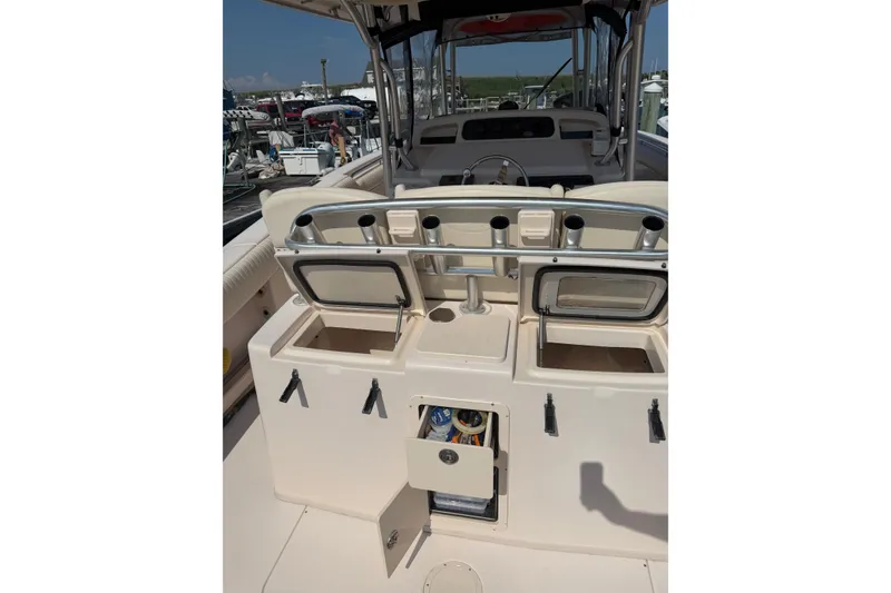 Slide: The Image of 2008 Grady-White Canyon 336 boat interior with storage compartments and rod holders. - 7