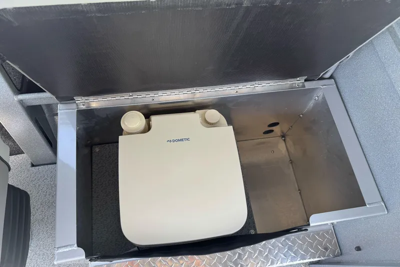 Slide: The Image of Storage compartment in a 2027 KingFisher 2025 Escape HT boat, featuring a Dometic unit. - 26