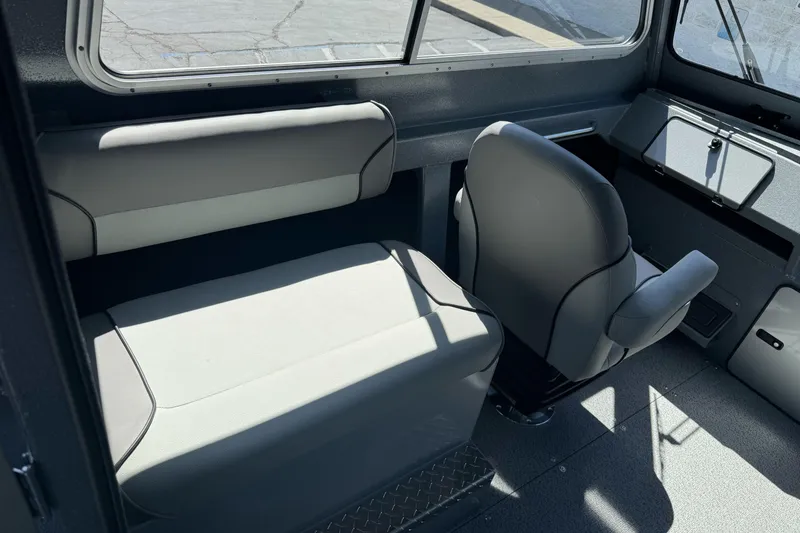 Slide: The Image of Interior of 2027 KingFisher 2025 Escape HT boat, featuring seating and dashboard. - 23