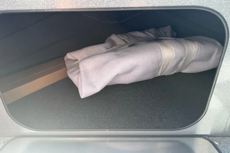 Slide: The Image of Storage compartment in 2027 KingFisher 2025 Escape HT, containing a rolled-up fabric item. - 35