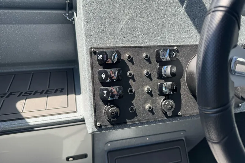 Slide: The Image of Control panel of 2027 KingFisher 2025 Escape HT boat with switches and steering wheel. - 29