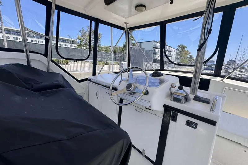 Slide: The Image of Interior view of 1982 Sunliner Ocean Yachts helm with steering wheel and controls. - 12