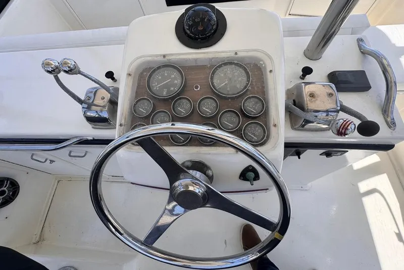 Slide: The Image of 1982 Sunliner Ocean Yachts helm with steering wheel and instrument panel. - 14