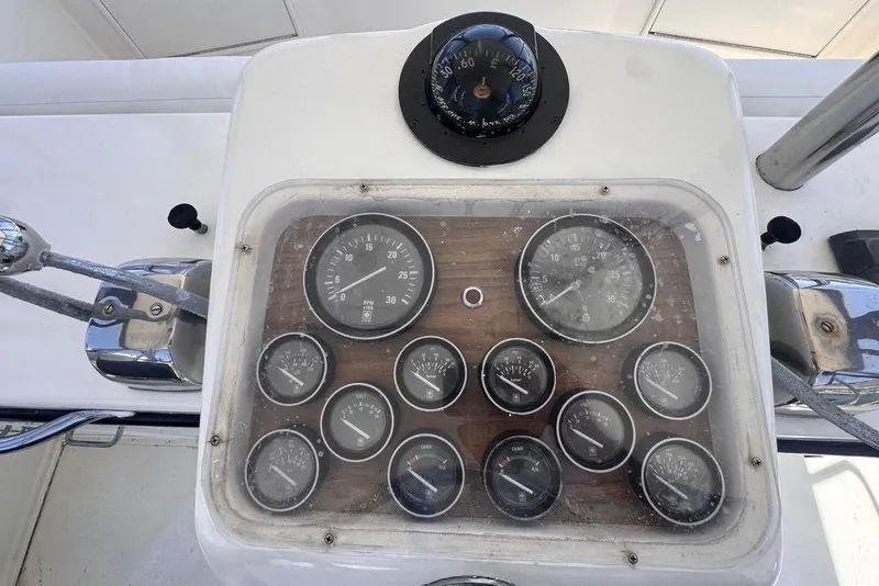 Slide: The Image of Dashboard of a 1982 Sunliner Ocean Yachts with gauges and compass. - 16