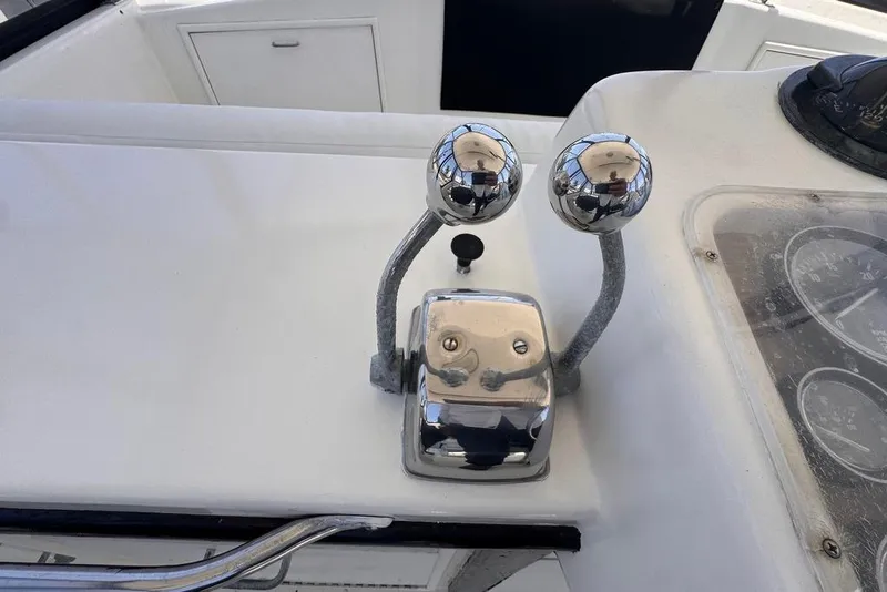 Slide: The Image of Chrome throttle controls on a 1982 Sunliner Ocean Yachts dashboard. - 17