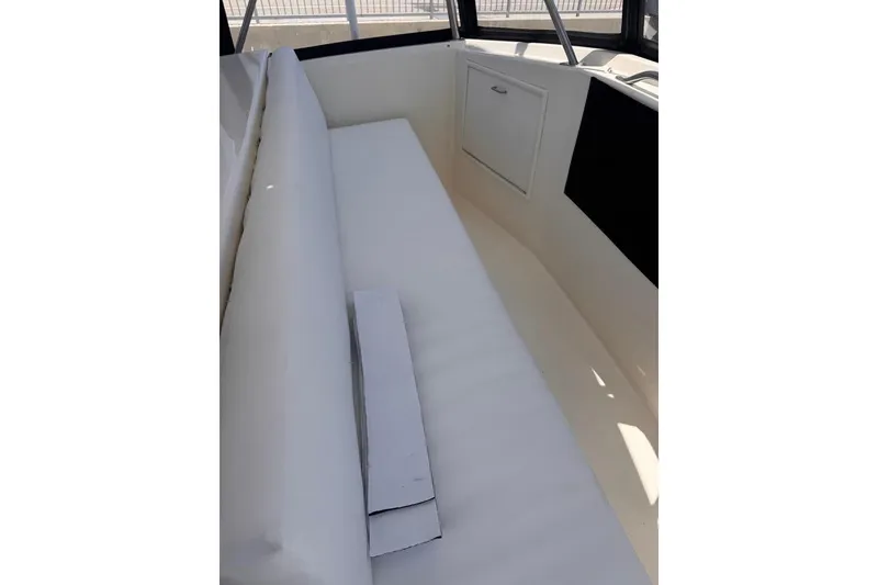 Slide: The Image of White seating area on a 1982 Sunliner Ocean Yachts boat interior. - 20