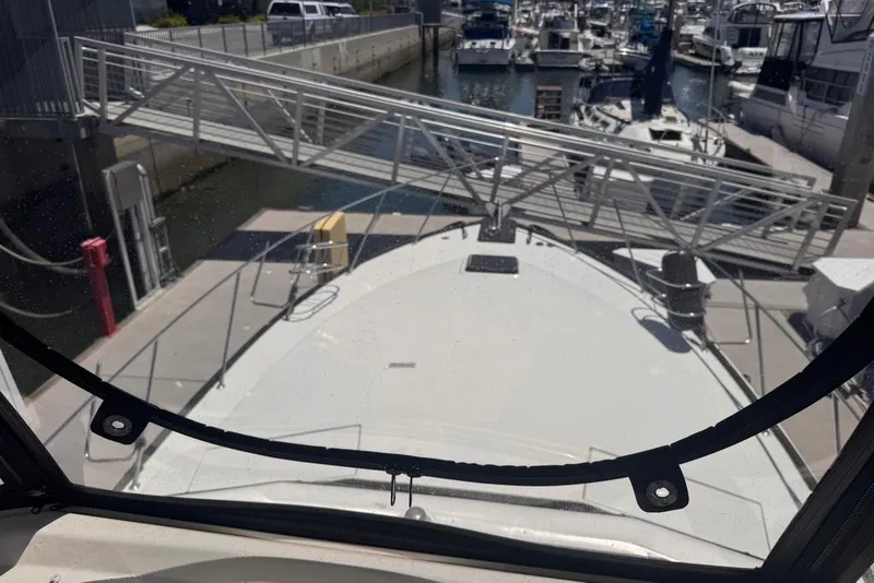 Slide: The Image of 1982 Sunliner Ocean Yachts docked at marina, viewed from the helm. - 21
