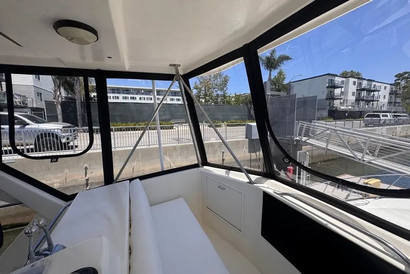 Slide: The Image of Interior view of 1982 Sunliner Ocean Yachts, docked near modern buildings. - 22