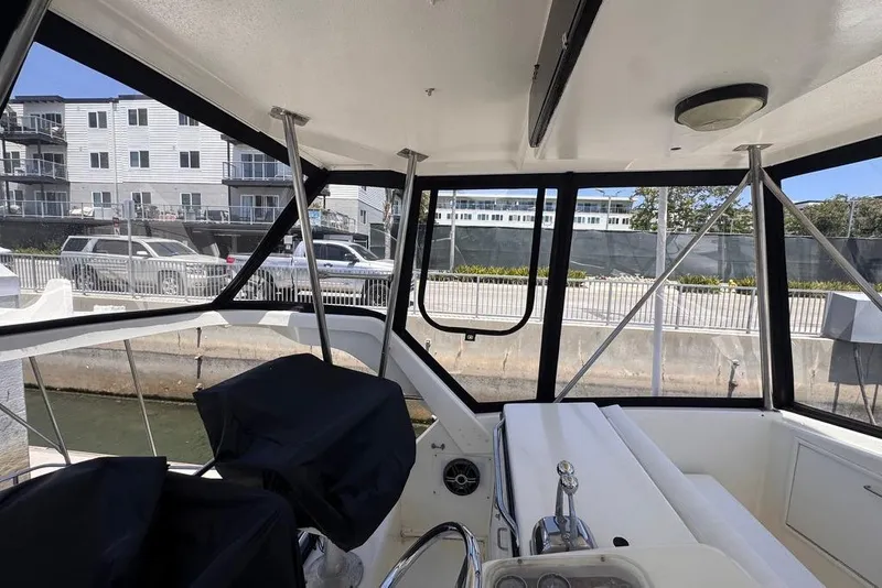 Slide: The Image of Interior view of a 1982 Sunliner Ocean Yachts boat docked near waterfront buildings. - 23