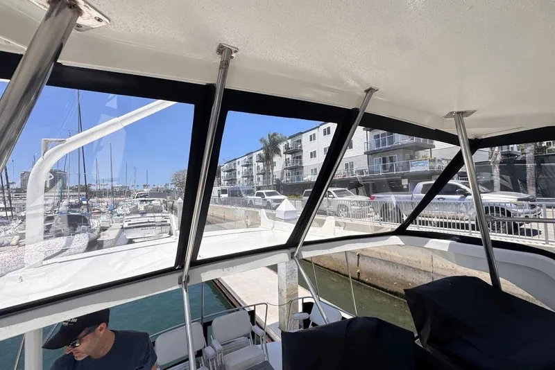 Slide: The Image of Interior view of 1982 Sunliner Ocean Yachts, docked at a marina with nearby buildings. - 24