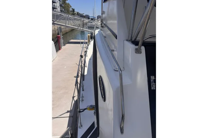Slide: The Image of 1982 Sunliner Ocean Yachts docked, showcasing sleek design and sturdy railings. - 26