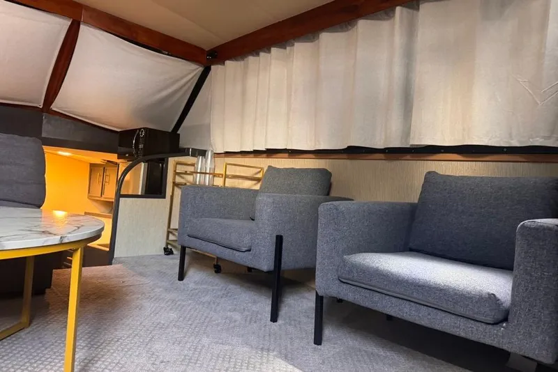 Slide: The Image of Interior of 1982 Sunliner Ocean Yachts with modern seating and marble table. - 28