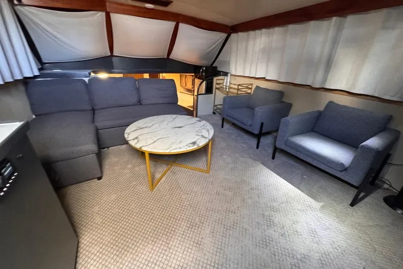 Slide: The Image of Luxurious 1982 Sunliner Ocean Yachts interior with modern seating and marble coffee table. - 30