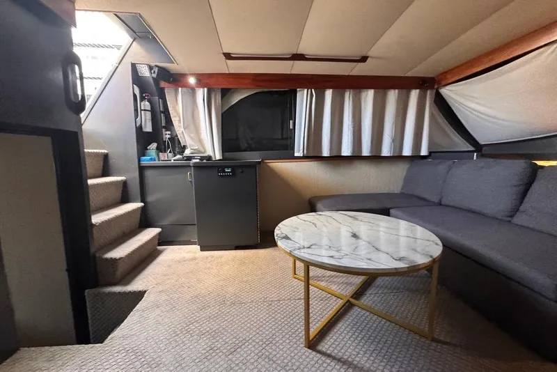 Slide: The Image of Interior of 1982 Sunliner Ocean Yachts with modern seating and marble table. - 31