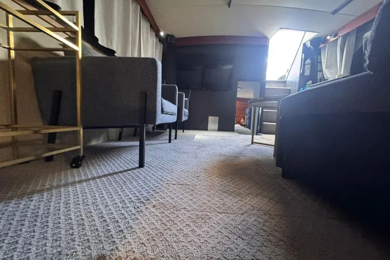 Slide: The Image of Interior of 1982 Sunliner Ocean Yachts, featuring cozy seating and carpeted flooring. - 38